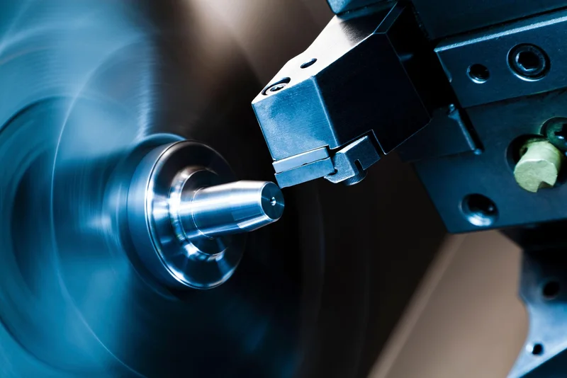 CNC turning tool machining a polished steel component